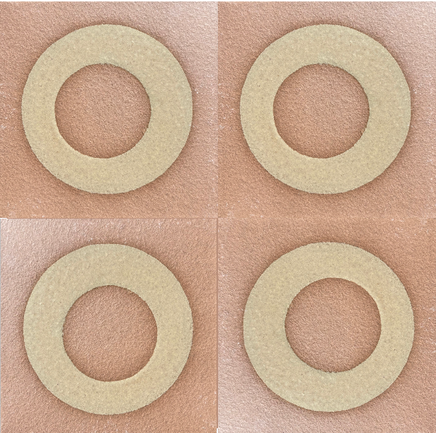 Four circular beige glaze patterns on terracotta background